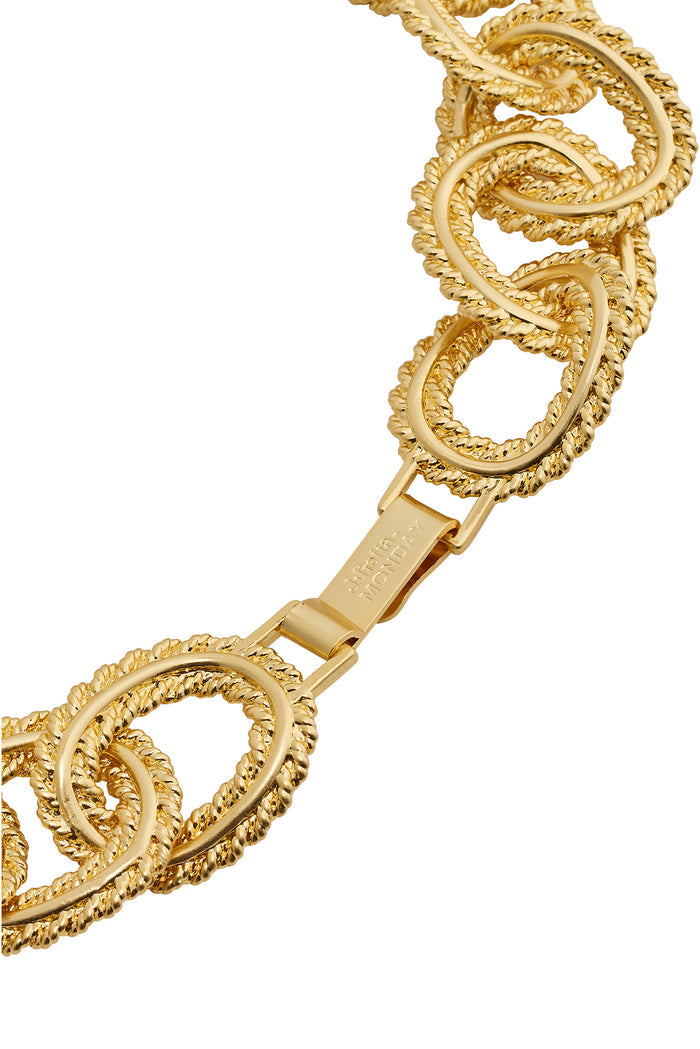 Close-up of Holbox necklace showing gold twisted-rope oval links and rectangular hook clasp on white background