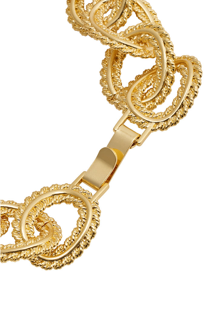 Gold-tone braided oval-link necklace with rope-textured links and flat clasp, close-up on chain detail