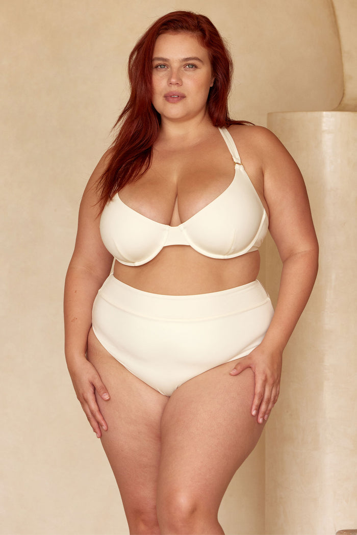 Front view of Honolulu Top in ivory showcasing underwire cups and halter straps with gold ring hardware on a neutral beige backdrop