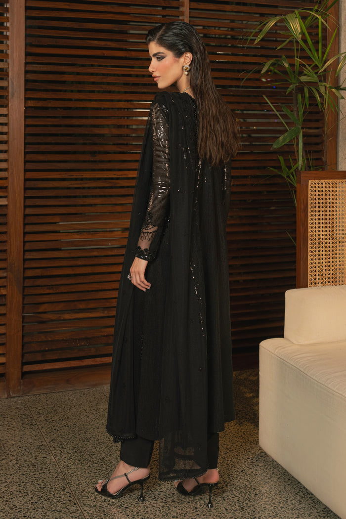 Back view of NAQSHI Horleyn black net outfit showing flowing shirt length, fitted sleeves, soft net fabric, and elegant evening silhouette.