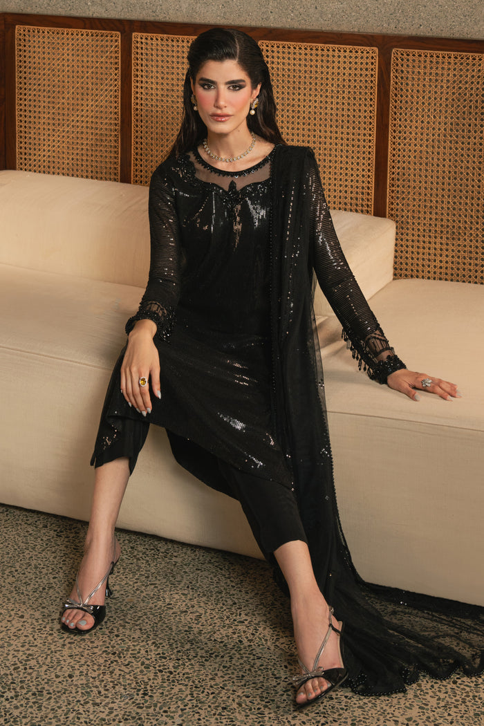 Front seated view of NAQSHI Horleyn black 3-piece formal outfit highlighting straight trousers, clean cut shirt, and polished evening look.