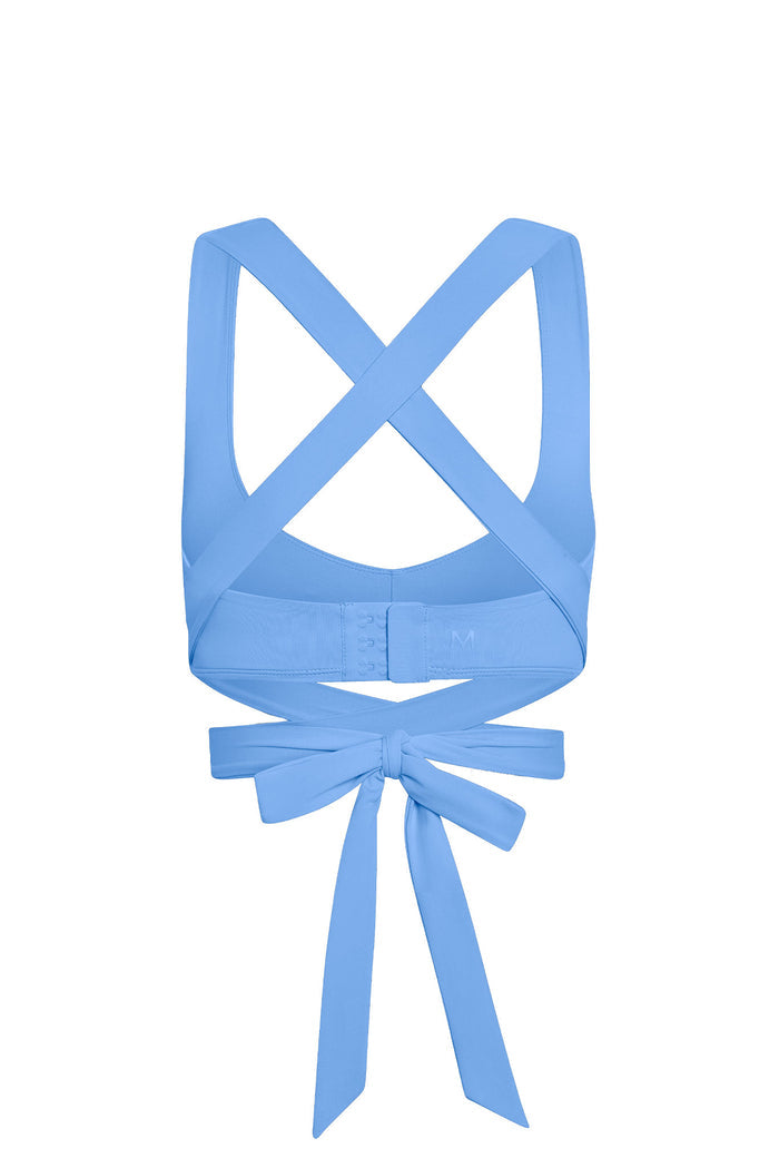 Back view of Hudson Bra in Azure showcasing crossed wrap straps, hook-and-eye band, and tied bow on white background