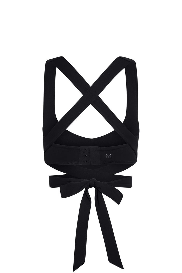 Back view of Hudson Bra in black showcasing crisscross straps, hook-and-eye back band, and tied wrap bow on a white background