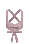 Back view of heathered dusty-rose sports bra with crossed shoulder straps and long wrap-around ties knotted at lower back.