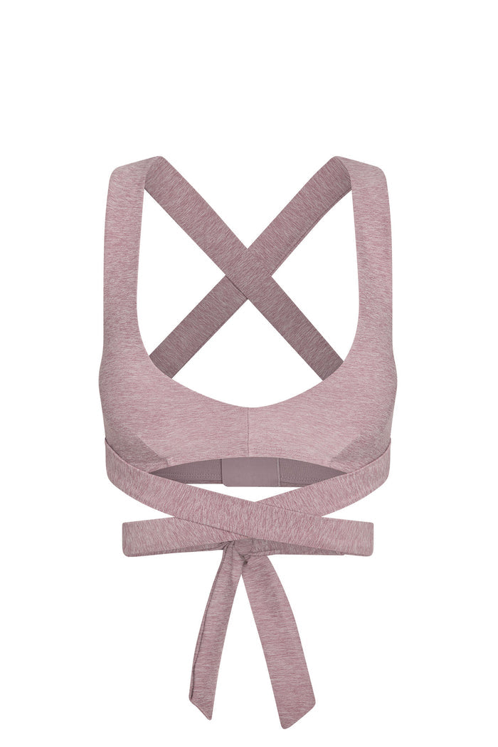 Back view of heathered dusty-rose sports bra with crossed shoulder straps and long wrap-around ties knotted at lower back.