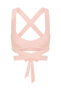 Back view of Hudson Bra in heather powder pink showcasing crossed back straps and long wrap-around tie on white background