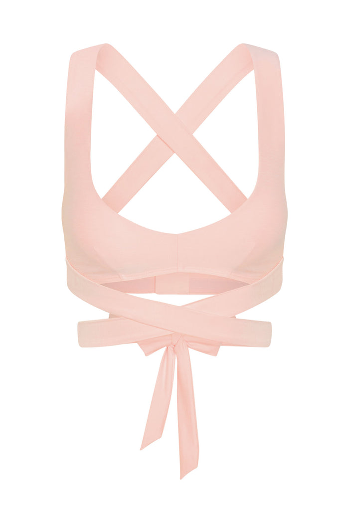 Back view of Hudson Bra in heather powder pink showcasing crossed back straps and long wrap-around tie on white background