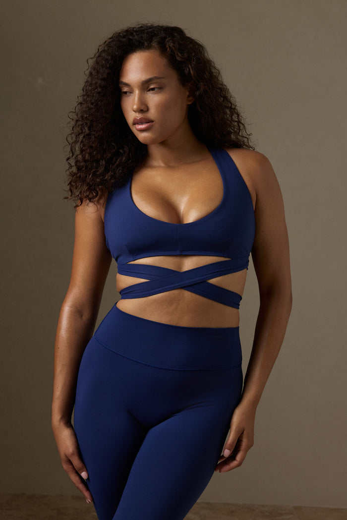 Front view of Hudson Bra in Midnight Jersey on model showing deep V-neck and crisscross wrap straps