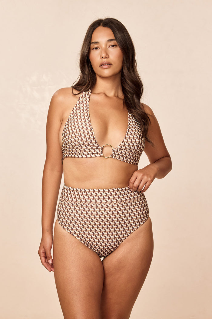 Front view of Ibiza Top in Husk Geo print showcasing plunging halter neckline and gold ring center on model against a beige background