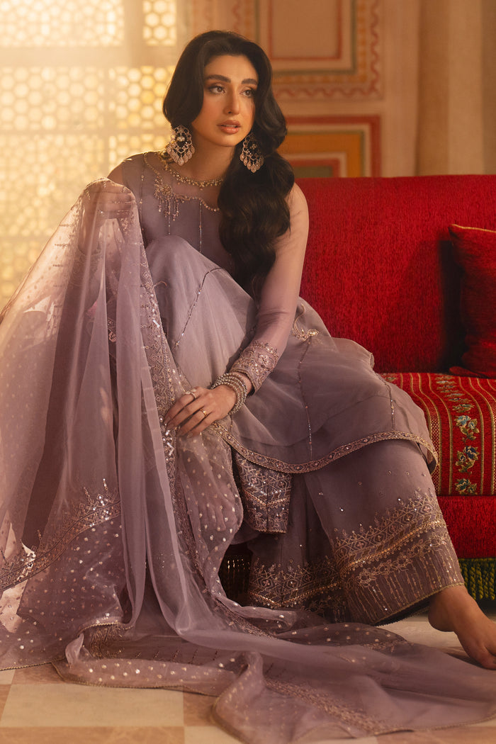 Lilac organza dupatta draped — featuring zari-panel detailing and sequin edged border.