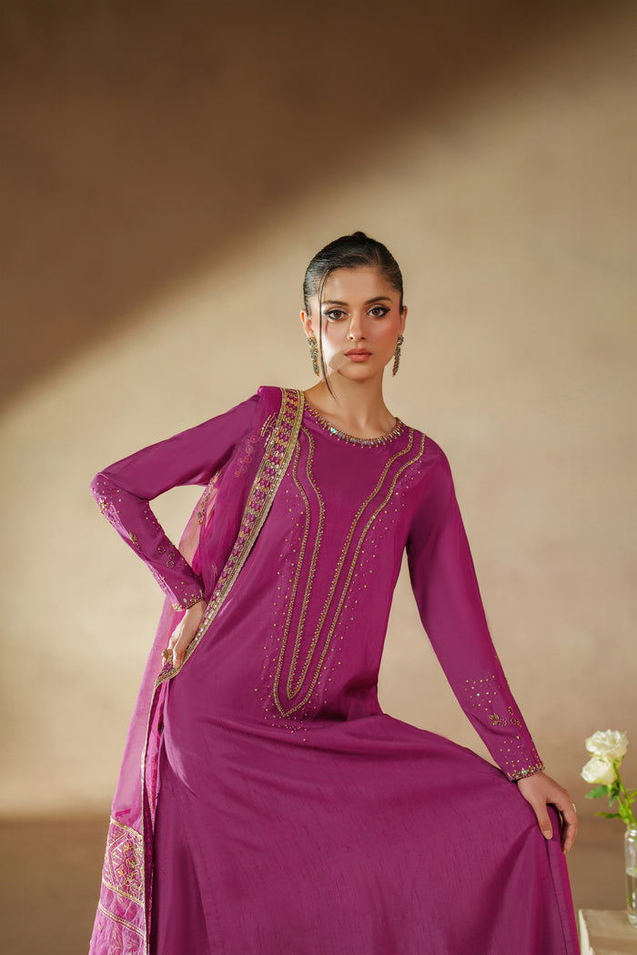 Seated pose of NAQSHI Imsha luxury pret outfit highlighting smooth raw silk fall, embroidered shirt, and elegant culotte fit.