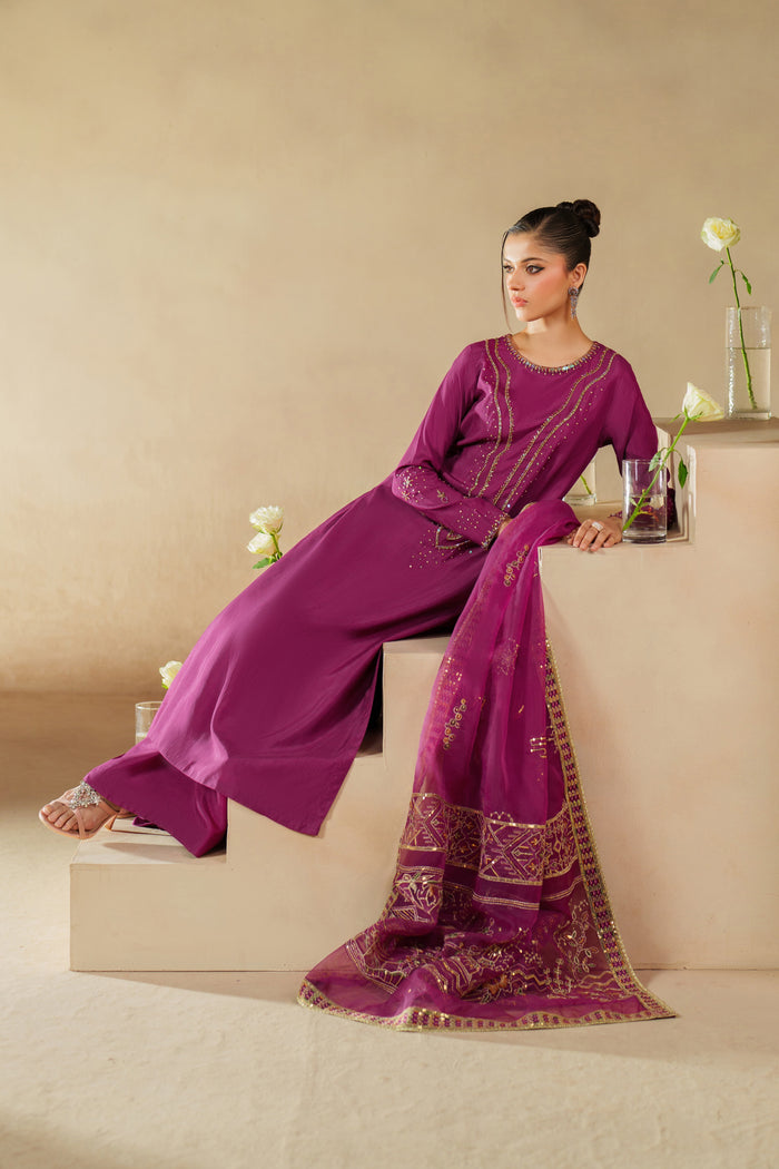 Styled relaxed pose of NAQSHI Imsha magenta luxury pret dress showing fabric flow, embroidery balance, and event-ready finish.