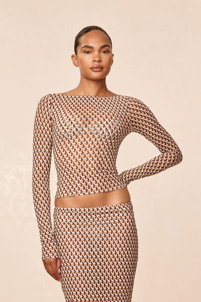 Front view of Ipanema Top in Husk Geo mesh showing sheer geometric print and fitted long sleeves on beige background