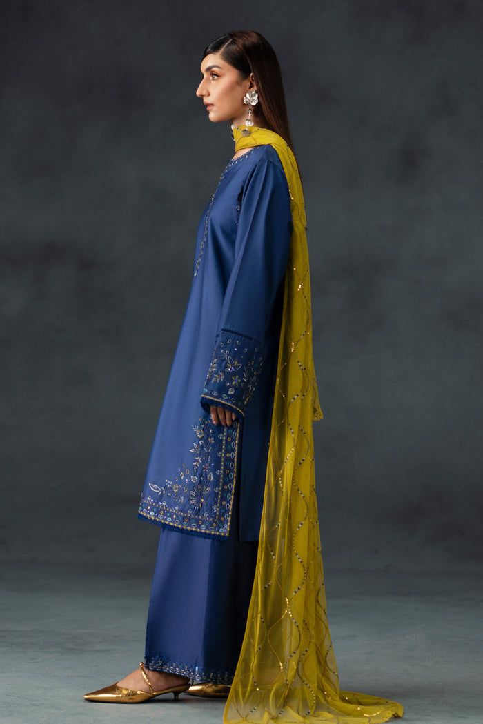 Back angle view of NAQSHI Irha blue ready-to-wear dress with mustard dupatta and embroidered borders, formal women’s outfit