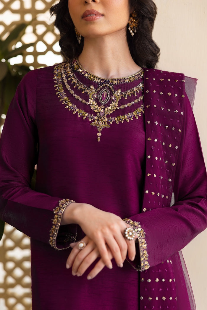 Side view of NAQSHI Irma showing straight-cut raw-silk shirt silhouette adorned with intricate hand-adda embroidery extending along sleeve seams and olive contrast culottes peeking.
