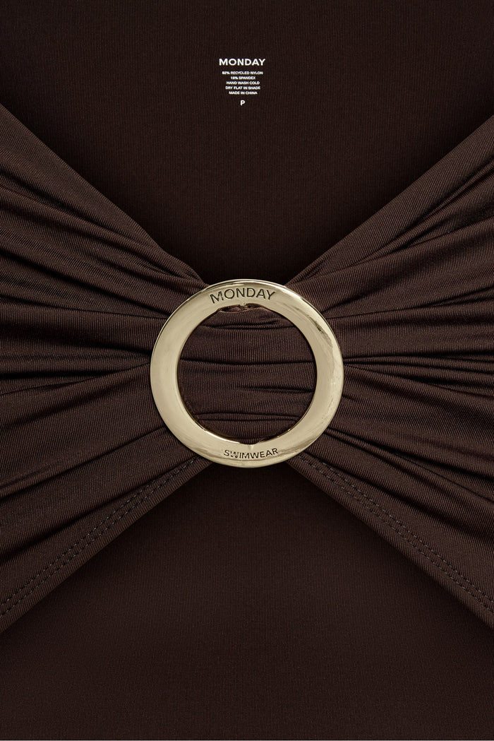 Close-up front view of Jamaica Sarong in Espresso showcasing gold round sliding buckle engraved MONDAY and ruched fabric background