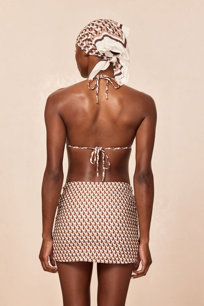Back view of Jamaica Sarong in Husk Geo print, mini length with adjustable gold buckle on neutral background