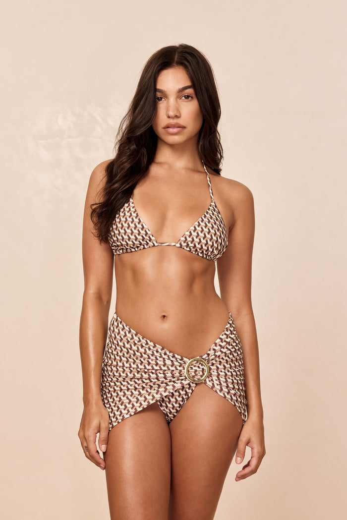 Front of Jamaica Sarong in Husk Geo brown print showing mini wrap with gold sliding buckle on model