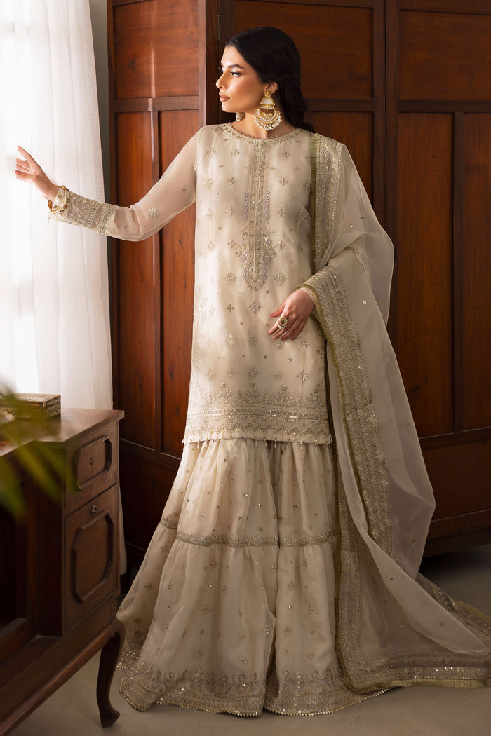 NAQSHI Jeena pearl-white organza shirt featuring a boat neckline crystallized with stones, floral sequin embroidery across front, paired with lavender-tinged gypsy gharara and embroidered dupatta.