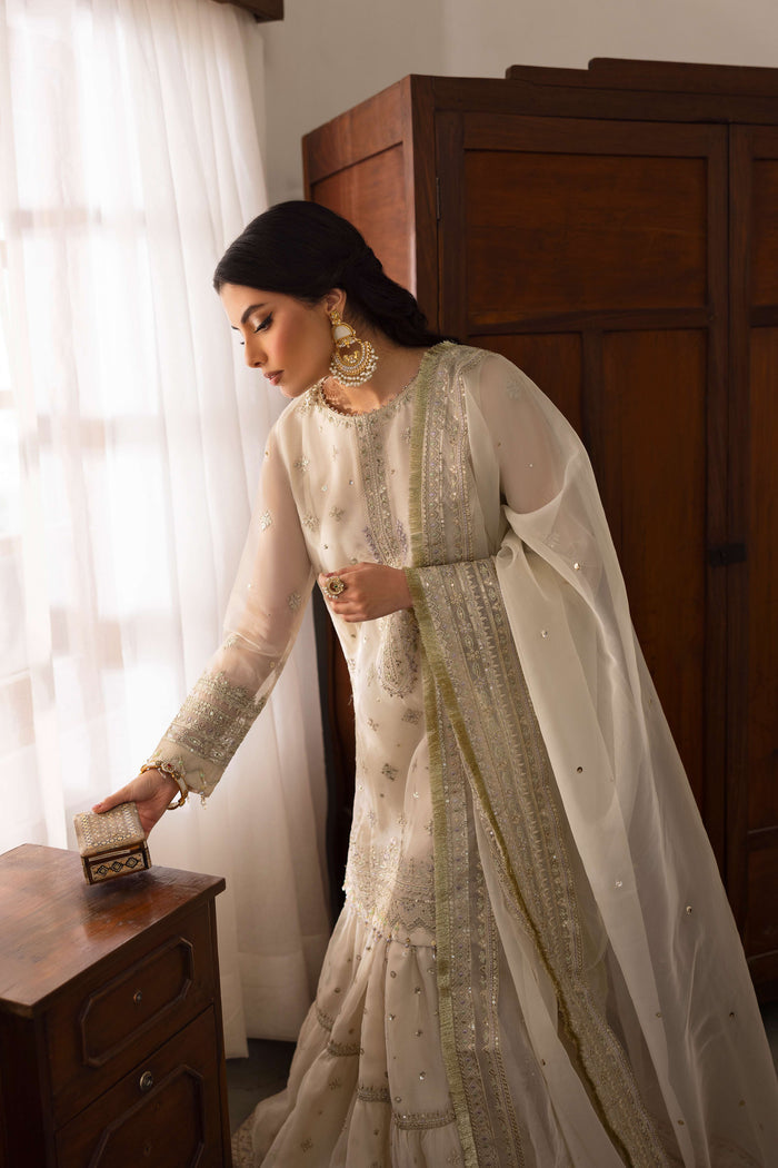 Side view of NAQSHI Jeena showcasing straight-cut organza shirt silhouette, floral embroidery continuing to side and full sweeping dupatta.
