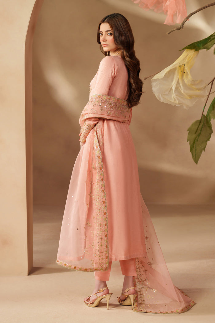 Side view of NAQSHI Jinan peach pink outfit showing elegant long shirt, straight trousers, and flowing embroidered dupatta.