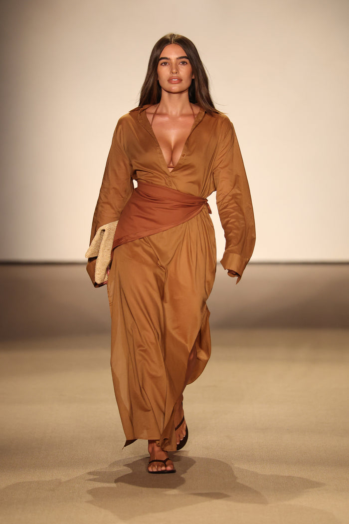 Front view of Kokomo Kaftan in caramel showcasing deep V neckline, wrapped waist sash and lightweight cotton voile on runway