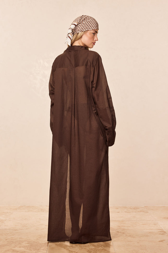 Back view of Kokomo Kaftan in Espresso showcasing semi-sheer cotton voile, long sleeves and collar on a neutral beige background