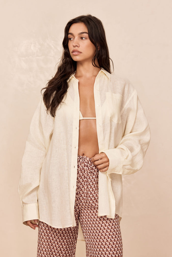 Front view of La Jolla Linen shirt in ivory, oversized fit, semi-sheer linen worn open on model, neutral background