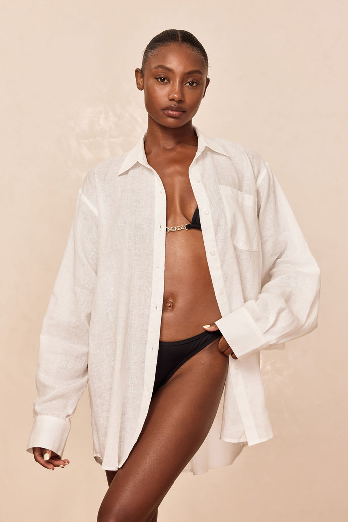 Front of La Jolla Linen Shirt, white linen, oversized fit, collar, chest pocket, center buttons, beige background