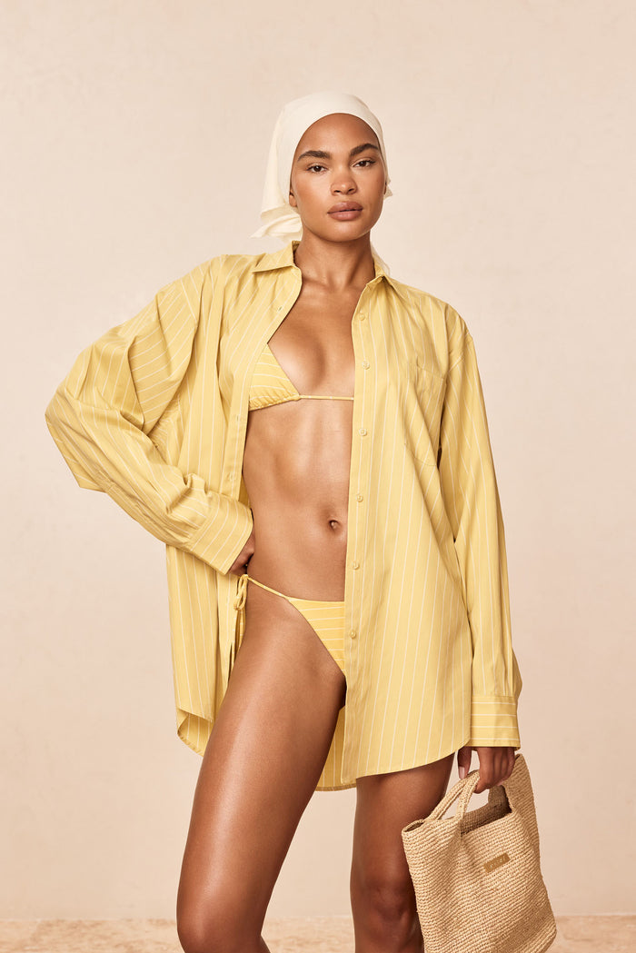 La Jolla Shirt Meyer Stripe, angled front view showing collar, buttons, pocket and vertical stripes on beige backdrop