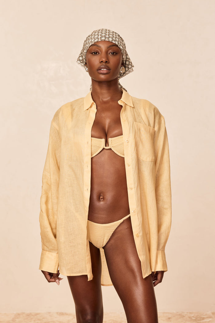Front view of La Jolla raffia linen shirt on model, oversized fit with open front, neutral beige background