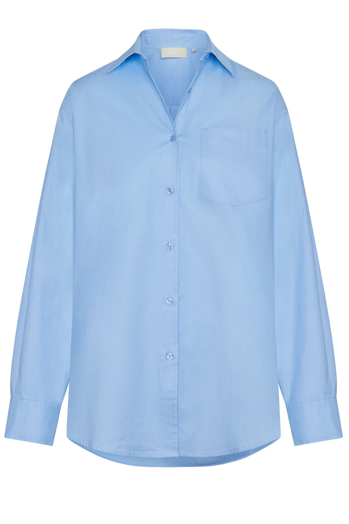 Front view of La Jolla shirt in sky blue showing button-front placket, chest patch pocket, long sleeves, and relaxed oversized fit on white background