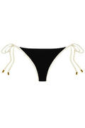 Front view of Le Marais bottom showcasing black fabric, ivory contrast trim and adjustable side ties with gold tips on white background