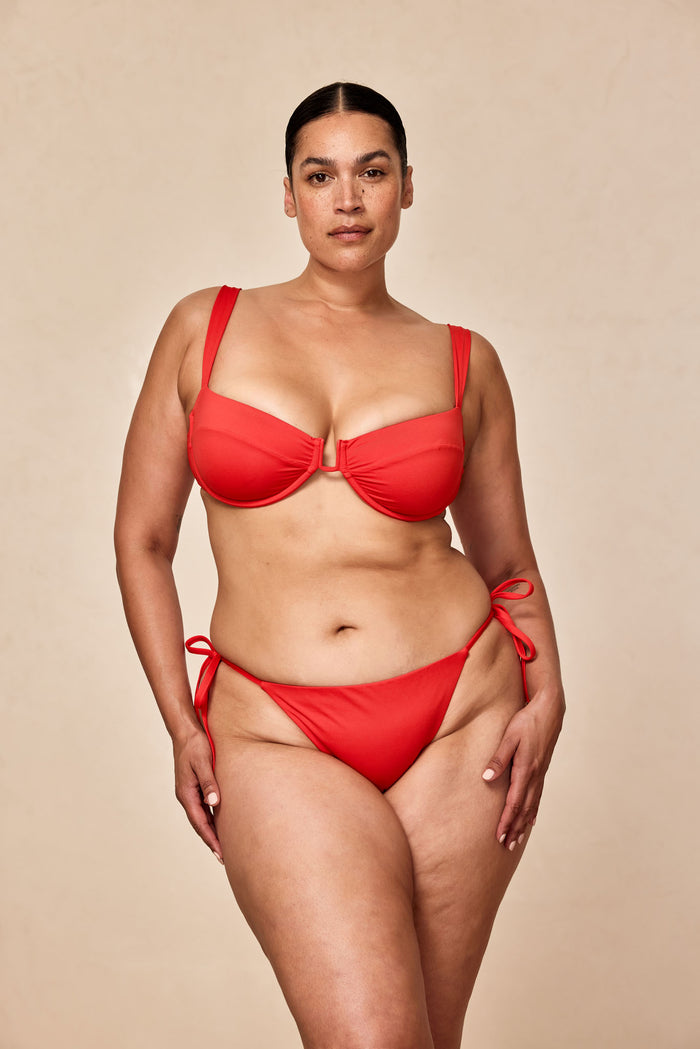 Front view of Cala Roja Top in Chili Pepper showcasing underwire balconette cups and U-shaped center hardware on a plus-size model