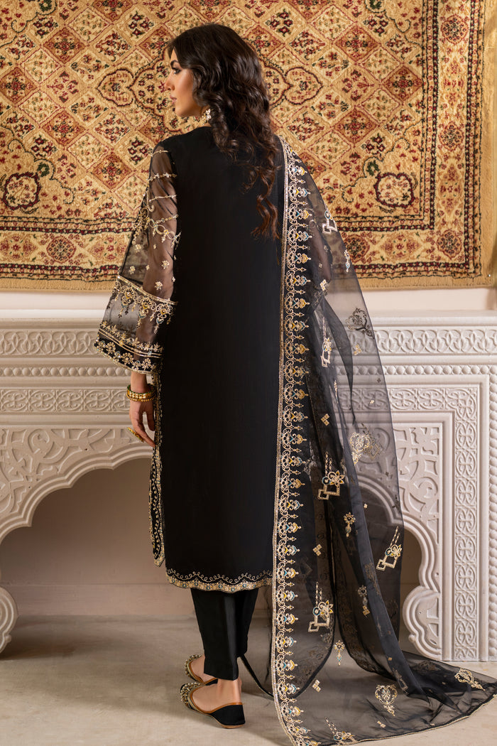 Side view of naqshi leena showcasing scalloped side seams, embroidered front-back patterns and loose-fitted sleeves with floral embroidery on organza.