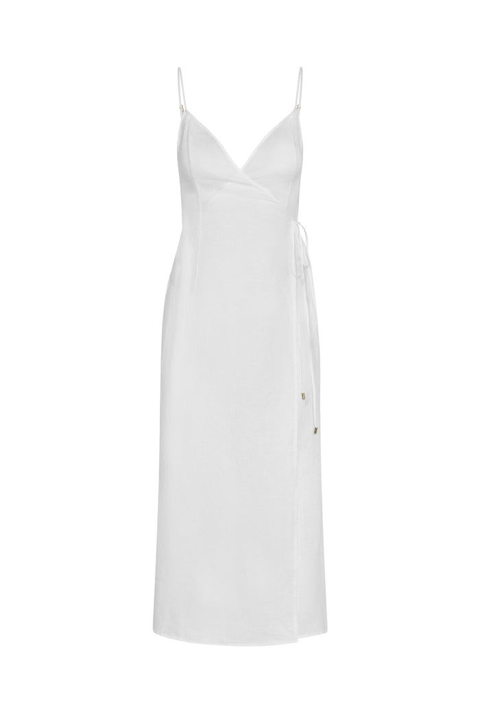 Front view of Levanzo Dress in white linen showing wrap V-neck, adjustable spaghetti straps and side tie on white background