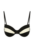 Black-and-ivory underwire bra with thin adjustable straps and curved two-tone cups.