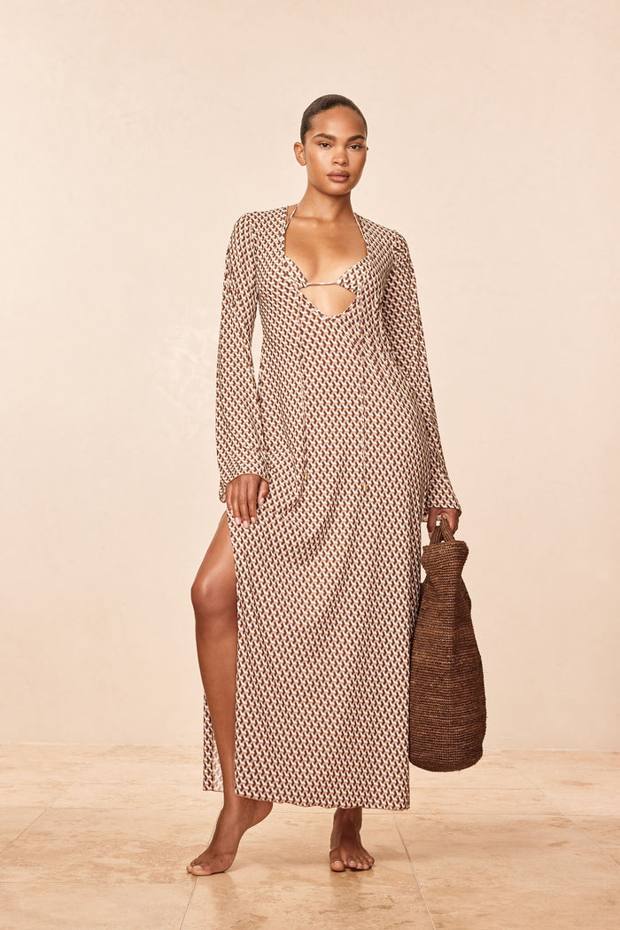 Three-quarter front of Marabella Kaftan in husk geo showing keyhole neckline, long sleeves, high side slit, woven tote
