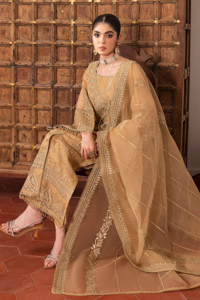 Model wearing full NAQSHI Marjaan 3PC set: angrakha‑style organza shirt with floral embroidery and crystal hangings, silk culottes & embroidered organza dupatta.