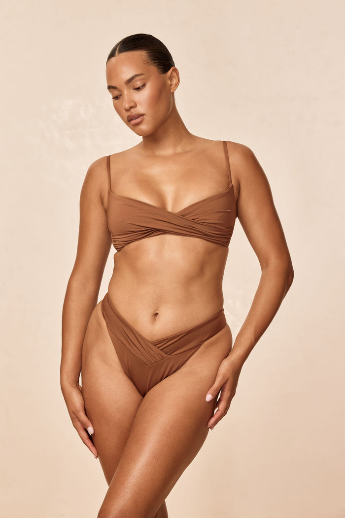 Front view of Marseille Bottom in Caramel showcasing V-front crossover and high-cut leg on model with neutral background