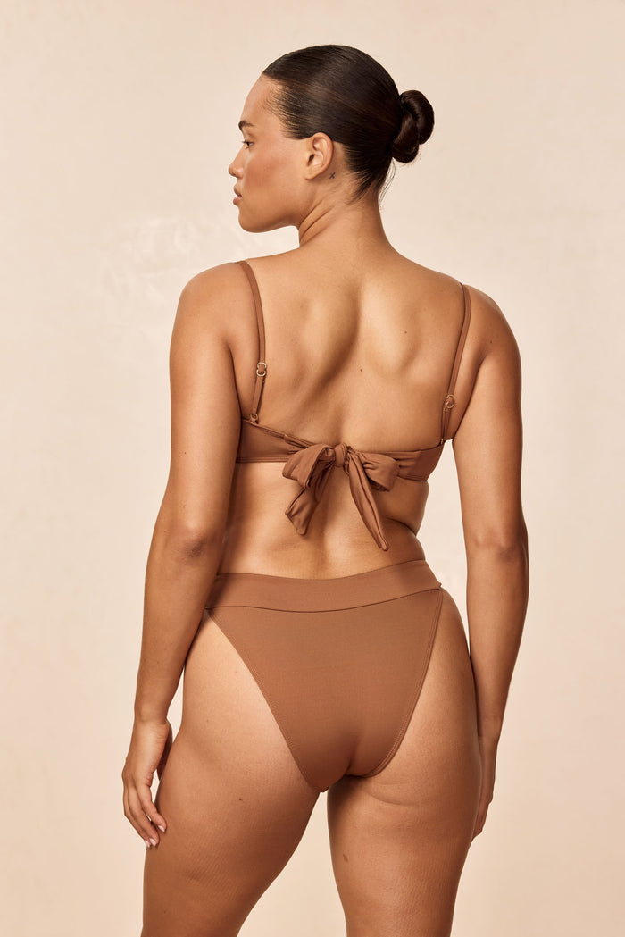 Rear view of Marseille Bottom in Caramel showcasing V-cut back, high-cut leg and cheeky coverage with neutral studio background