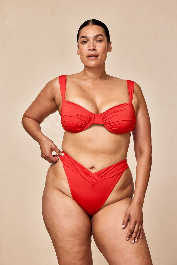 Front view of Marseille bottom in Chili Pepper on plus-size model showing V-front waist and high-leg cut, neutral background