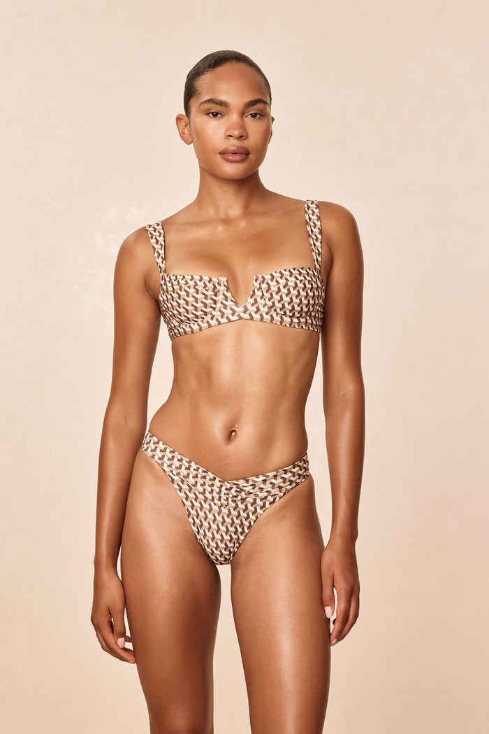Front view of Marseille Bottom Husk Geo showing high-cut thong fit and brown-and-cream print on model against beige background