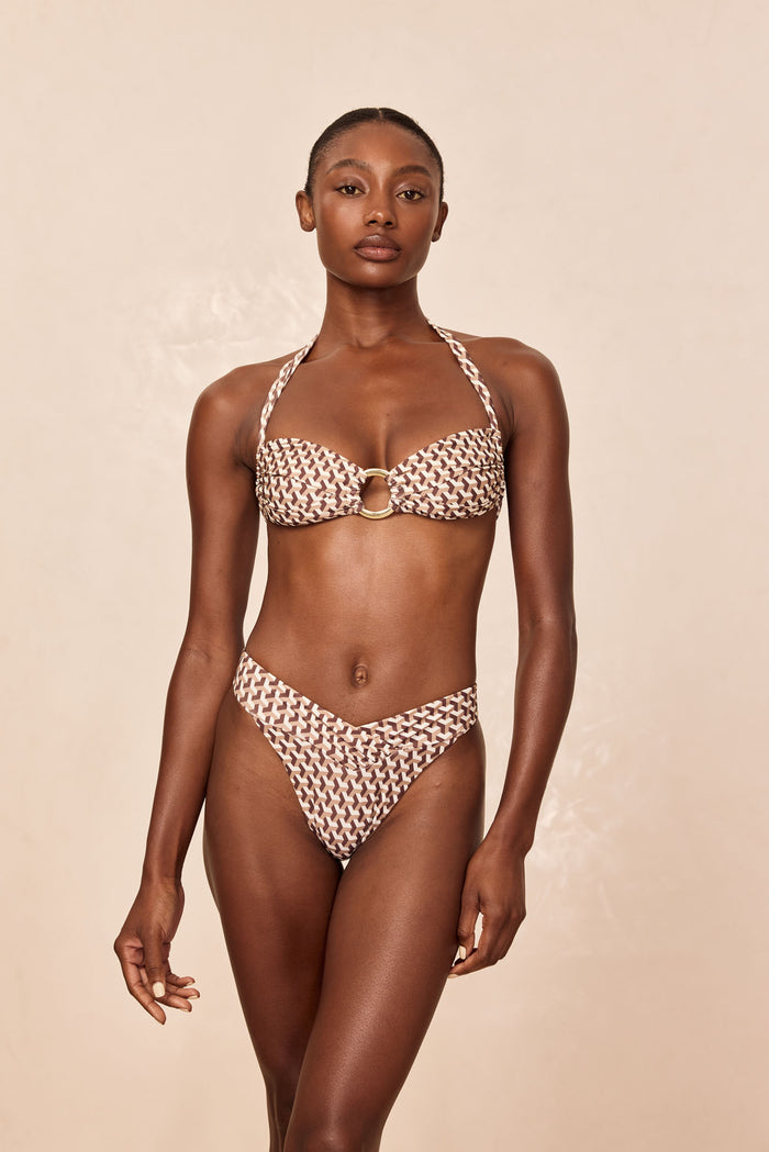 Front view of Marseille Bottom in Husk Geo showing V-front shirred waist, high-leg cut and cheeky coverage on beige background
