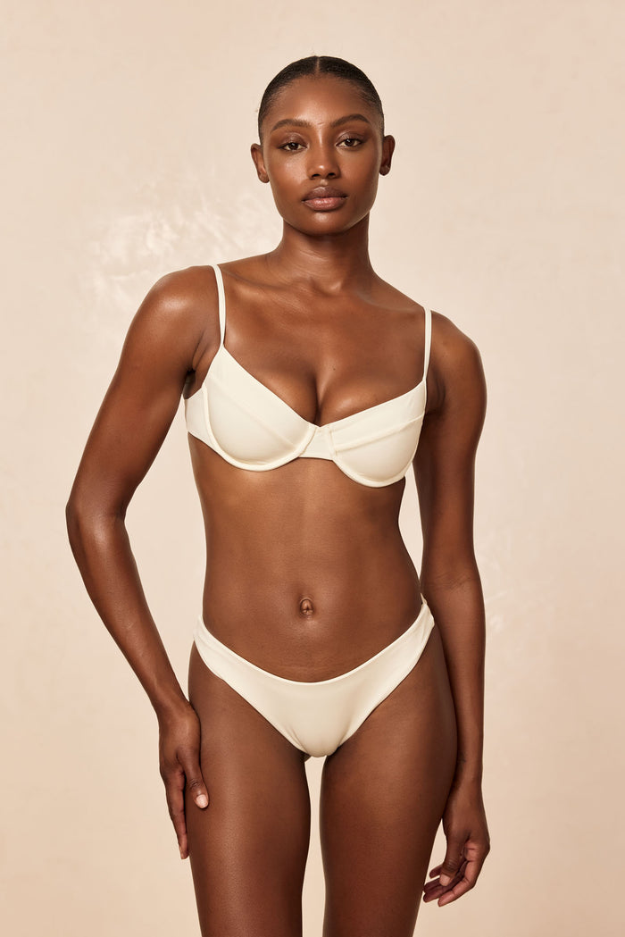Front view of Maui Top in ivory showcasing underwire cups and thin adjustable straps on beige studio background