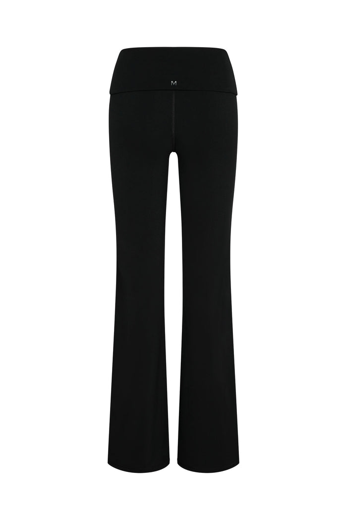 Black high-waist flared yoga pants, back view, with small white M logo centered on waistband