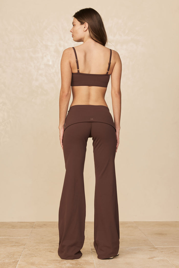 Back view of Melrose Flared Legging Long in Espresso showing high-rise waistband, center-back M logo, and long flared legs