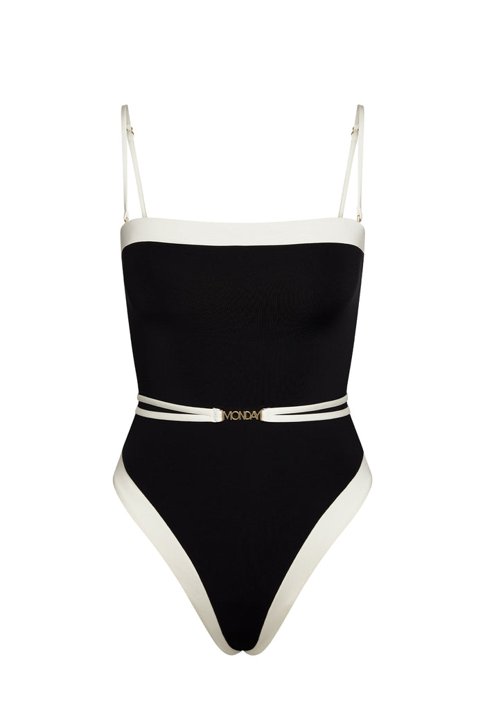 Black one-piece swimsuit with white trim, thin adjustable straps and double white belt with gold "MONDAY" buckle.