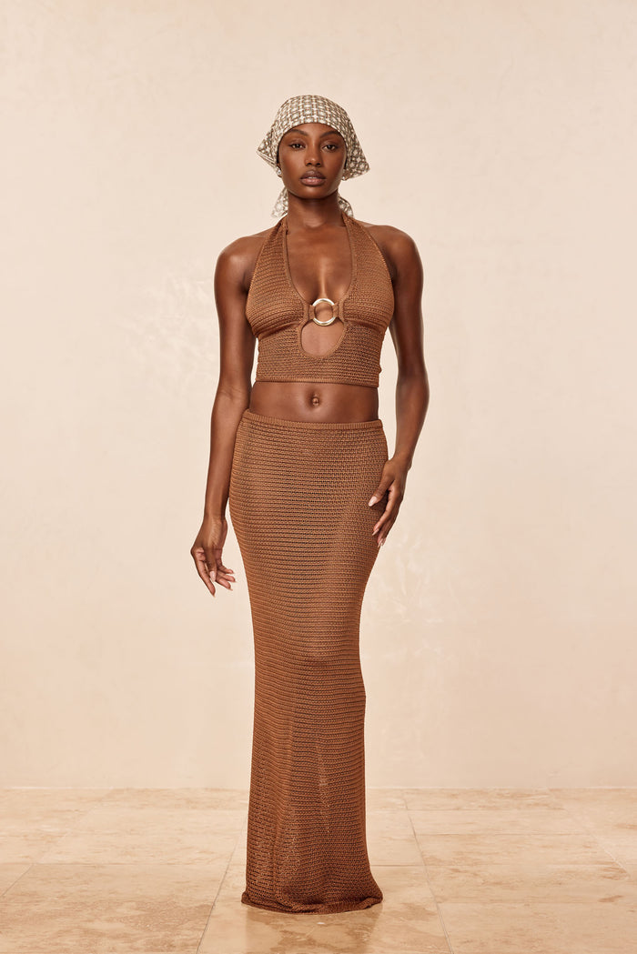 Front of Miami Top, Caramel treble knit, halter neckline with V front cutout and gold ring, cropped fit, beige background