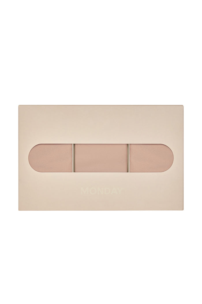 Top view of Monday G-string 3-pack in blush showing three minimal-coverage g-strings in blush box with oval window